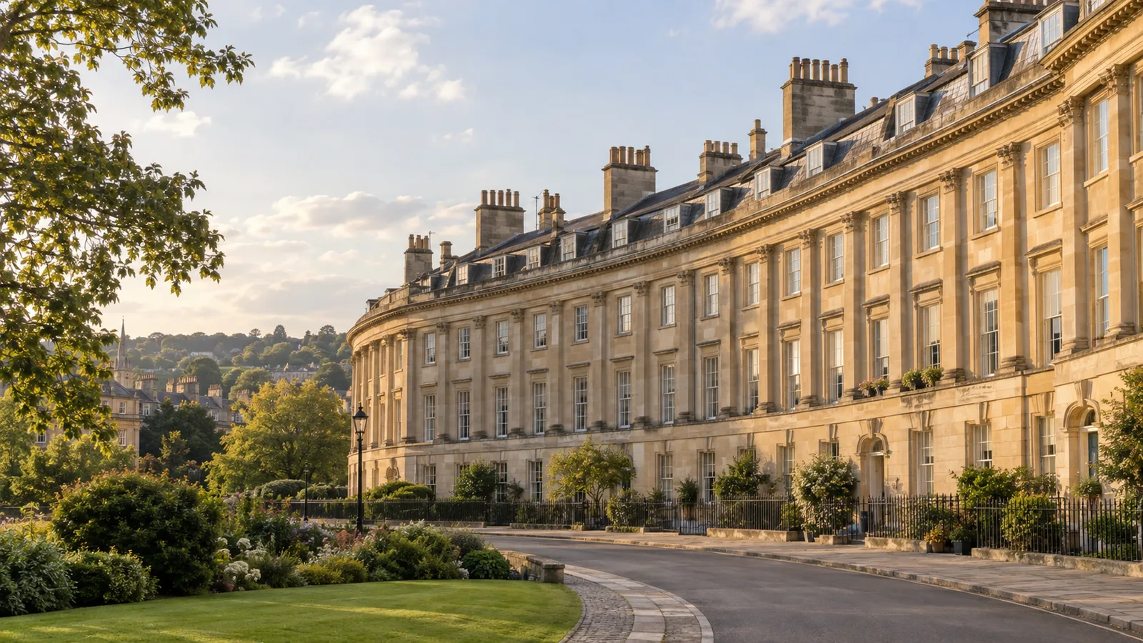 Bath's honey-coloured Georgian crescent buildings under a soft afternoon sky